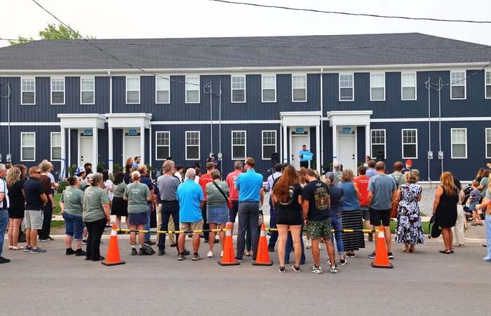 Ribbon cutting outside a new affordable housing development in Welland